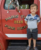 Paris Township boy poses in front of Fire Truck