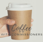 Coffee with Commissioners hand holding coffee cup.